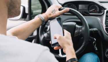 man using cellphone while driving