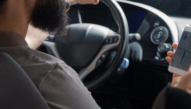 Man using mobile phone while driving